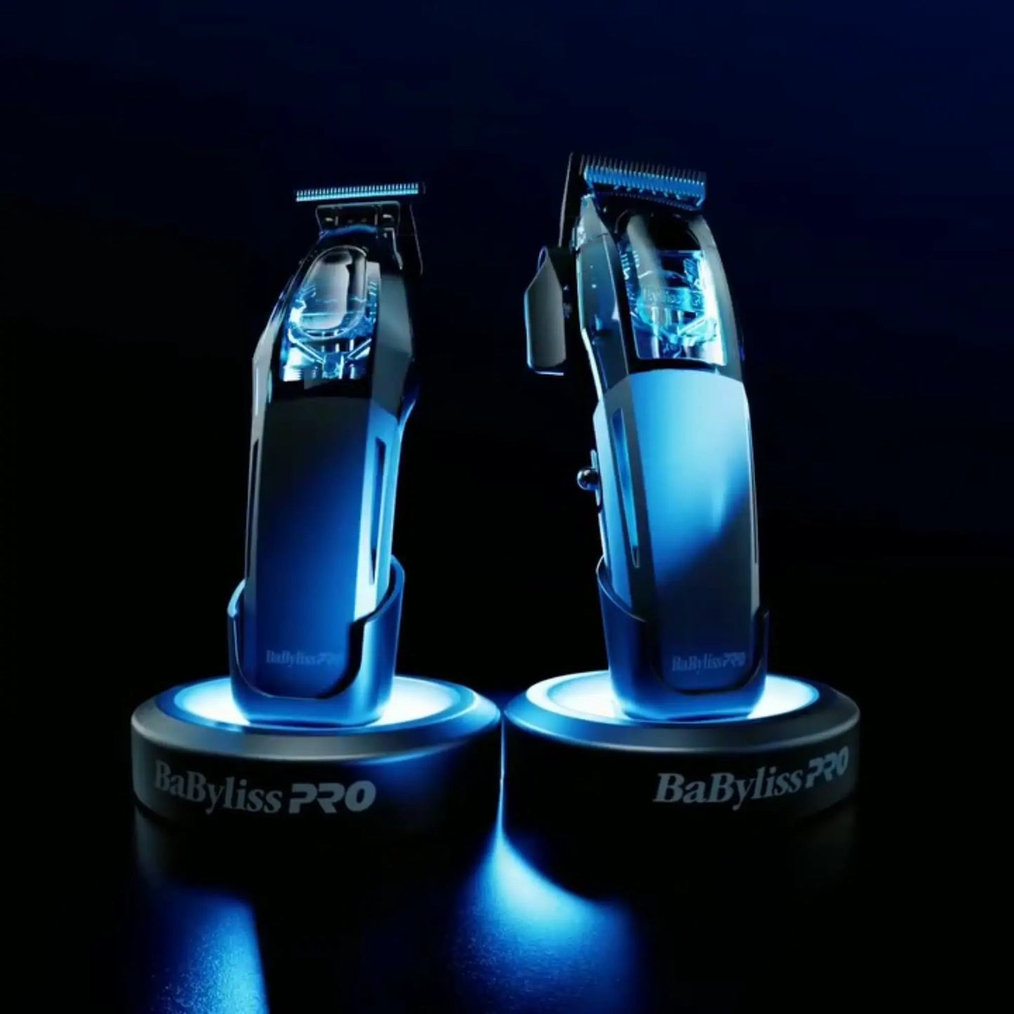Two BaByliss PRO hair clippers on illuminated stands against a dark background