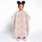 Child wearing a colorful unicorn pink animal-patterned poncho on a white background