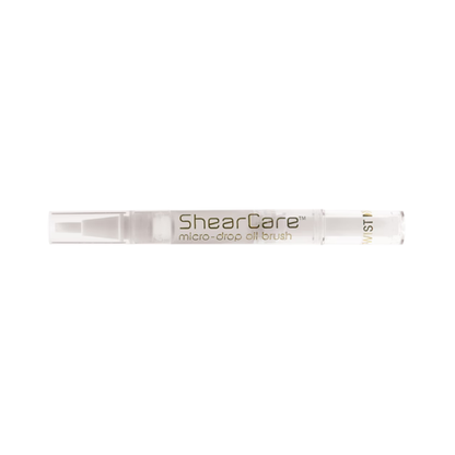 ShearCare micro-drop oil brush in a clear cylindrical container with gold lettering, shown horizontally against a plain white background.