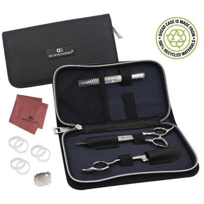 Olivia Garden scissor case kit shown open on a white background, with a black zippered carrying case, metal hair scissor and thinner, white finger hole rings, shear oil and a red cleaning cloth. A circular badge in the top right says the case is made from