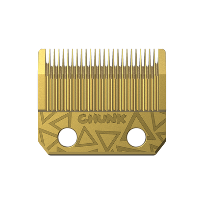 Gold hair clipper blade with geometric design on a white background